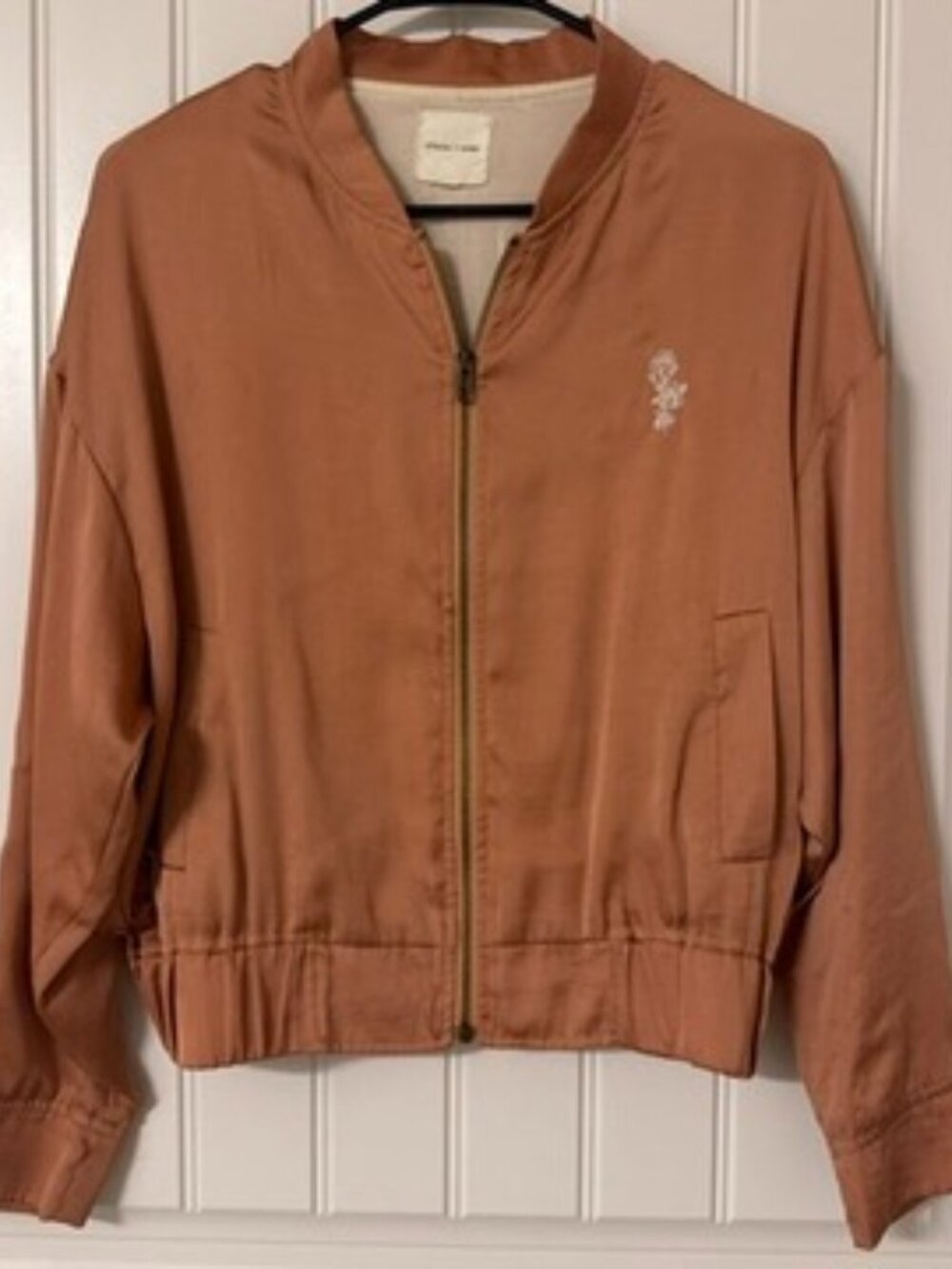 Rose gold bomber jacket with white flower embroidery